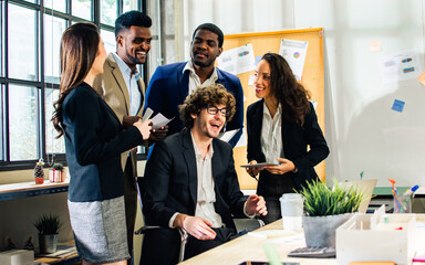 Diverse and multiracial smart businesspeople wearing formal suits, using computer, working, meeting, brainstorming together about company marketing plan or creative idea in indoor modern office.