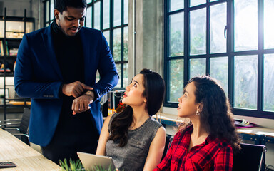 Diverse and multiracial smart businesspeople wearing formal suits, using computer, working, meeting, brainstorming together about company marketing plan or creative idea in indoor modern office.