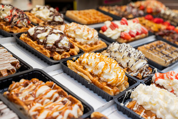 national food waffles in Belgium on the square in pastry shops with chocolate cream and berries