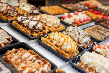 Fotobehang national food waffles in Belgium on the square in pastry shops with chocolate cream and berries © Sheviakova