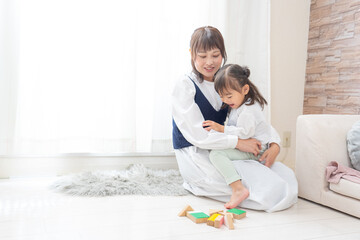 Obraz premium 女の子を抱っこして遊ぶお母さん