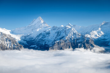 Obraz premium Mountains peaks and clouds in the valley. Natural landscape. Mountain range through the clouds. Landscape in the summertime. Large resolution photo.