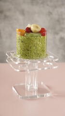 fruit cake with banana, orange, cherry, kiwi and blackberry on it