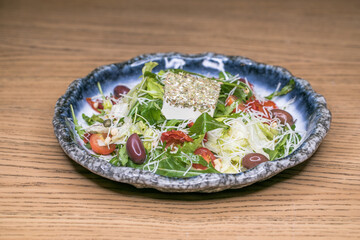 Restaurant dish meat salad on a blue plate