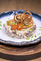 Restaurant dish meat salad on a blue plate