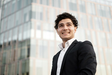 Portrait of a confident man in a business suit looks away and smiles