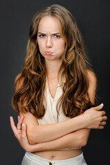 Naklejka premium portrait of sad or offended girl with pouted lips, isolated on gray background