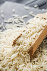 raw basmati rice on a black wooden background