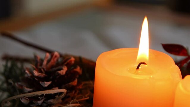 Burning Christmas candles of a festive Christmas wreath with four candles burning in advent time for cozy atmosphere in Christmas season on holy eve or xmas preparation with tranquil mood and coziness
