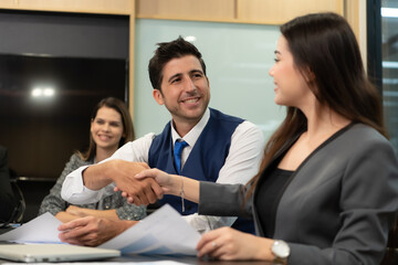 New business people in the conference room are exchanging information with each other along with rehearsing important information before presenting work and new projects to the management team