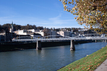 Fototapeta premium The footbridge in Salzburg follows downstream after the Karolinenbridge