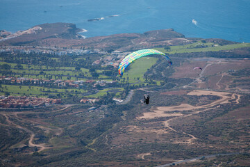 paragliding in the mountains. A paraglider flies in Tenerife. Ocean view.