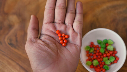 Withania somnifera or ashwagandha leaves and red fruit berries in white cup. winter cherry. healthcare