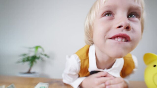 Smiling caucasian 5 years old boy makes funny face close to the camera. 