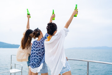 Group of Asian woman friends enjoy and fun outdoor lifestyle celebrating holiday party drinking...