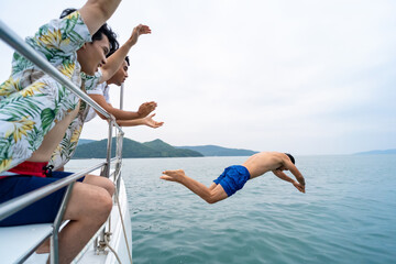 Group of Handsome man friends enjoy and fun outdoor lifestyle jumping to the sea and swimming...