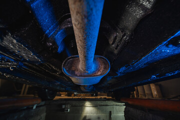Vehicle underbody exhaust pipe, catalyst, resonator, exhaust system. Car service and maintenance. Standards and technical condition. anti-corrosion coating of the bottom of the car. Selective focus