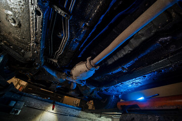 Vehicle underbody exhaust pipe, catalyst, resonator, exhaust system. Car service and maintenance....