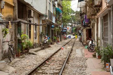 Fototapeta na wymiar Street with train tracks, Hanoi, Vietnam　ベトナム・ハノイ 線路沿いの街並み トレインストリート