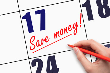 17th day of the month. Hand writing text SAVE MONEY and drawing a line on calendar date.