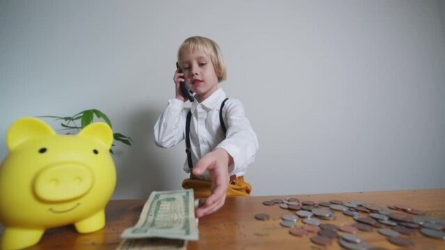 Piggybank abd money, blinkling lights. Little businessman counts banknotes