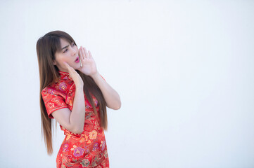 Portrait beautiful asian woman in Cheongsam dress on white background,Thailand people,Happy Chinese new year concept,Happy  asian lady in chinese traditional dress