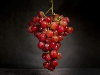hanging grapes on a black background