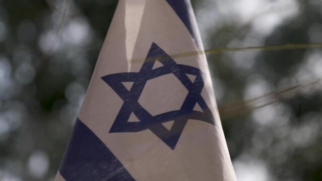 Flag of Israel in the sun. Slow motion shot of the flag of the holy land Israel. 