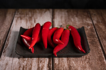 Red pepper lies on the table in the kitchen 

