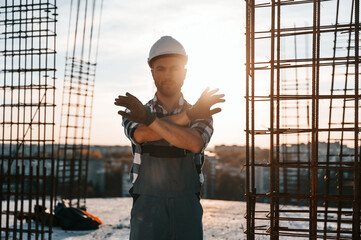 Restricted area. No trespassing. Man is working on the construction site at daytime