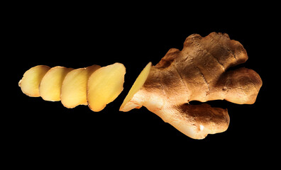 Root of sliced ginger on black background