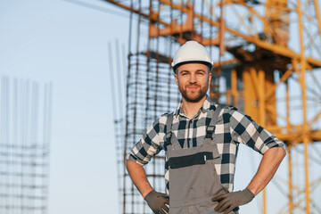 Handsome man is working on the construction site at daytime
