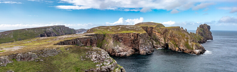 The cliffs and sea stacks An Tor Mor and the Wishing Stone at Port Challa on Tory Island, County Donegal, Ireland © Lukassek