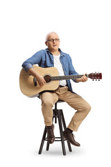 Mature man with an acoustic guitar sitting on a chair and singing