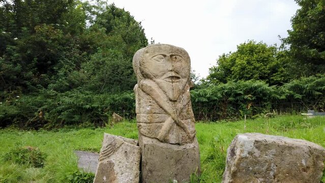 This is a bronze age stone carviing with two faces,called Janus, located In Caldragh Cemetery on Boa Island, Lower Lough Erne. Northern Ireland