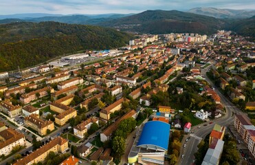  Aerial view of a small city from Romania. Apartment buildings, streets and vegetation is depicted in the picture. Name of city: Resita.
