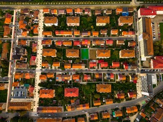  Aerial view of a small city from Romania. Apartment buildings, streets and vegetation is depicted in the picture. Name of city: Resita.
