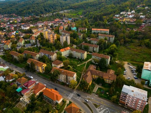  Aerial view of a small city from Romania. Apartment buildings, streets and vegetation is depicted in the picture. Name of city: Resita.
