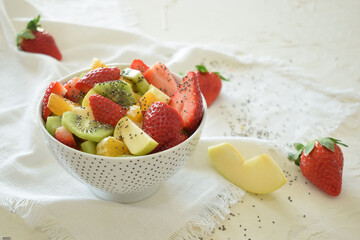 Bowl of fresh fruit salad, kiwi, apples, oranges