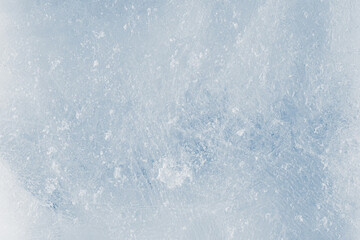Rough ice texture, light blue tones background. The textured cold frosty surface of the ice.