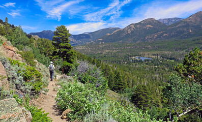 Hiker descends trail from Lake Bierstadt in Rocky Mountain National Park, Colorado
