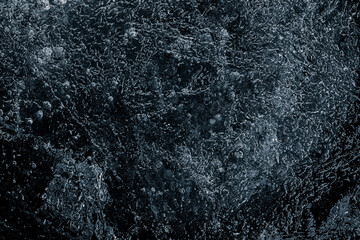 Fototapeta na wymiar Natural textured ice surface black background.