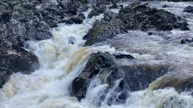 River Dee fast flowing due to high water level during the winter at the Bridge of Feugh