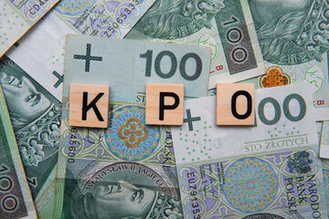 Inscription KPO which is Krajowy Plan Odbudowy next to Polish Money. Concept showing Next Generation EU program for Poland