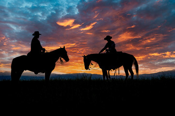 Cowboys on horseback at first light