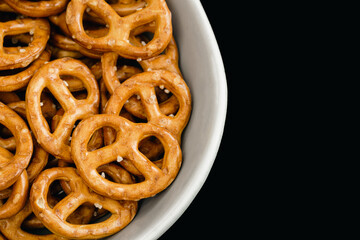 Close-up, pretzels in a plate on a black background.