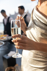 Woman is enjoying the sunset with a glass of wine
