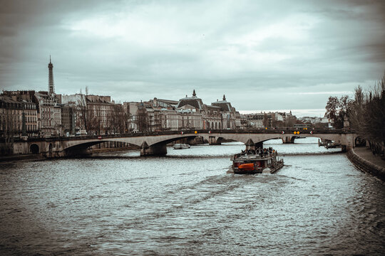 The Effel tower in Paris, while a boat travels the Seine