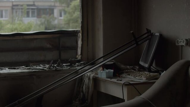 Slow motion, abandoned civilian apartment in Ukrainian Kharkiv, eastern Ukraine. Broken windows, shattered glass and signs of fire in apartment destroyed by russian missile rocket strikes, 25.05.2022