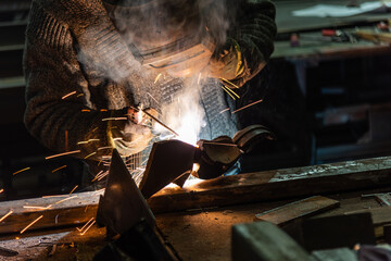 Welding process in the industrial workshop by worker